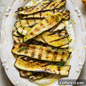 vertical shot of grilled zucchini on a bed of whipped feta