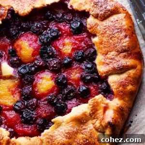 Top down of finished plum and blueberry galette