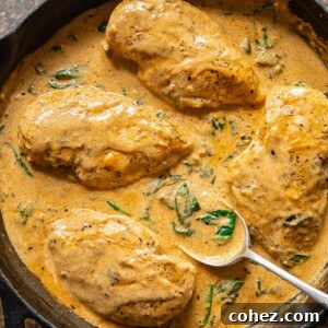 chicken breasts in a creamy sauce in a cast iron pan