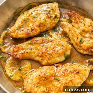 top down view of chicken breasts in lemon sauce in a pan